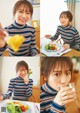 A woman sitting at a table with a plate of food.