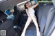 A woman sitting in the back seat of a car.