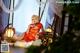 A woman in a red dress sitting on the floor.