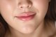 a close up of a woman's face with long brown hair